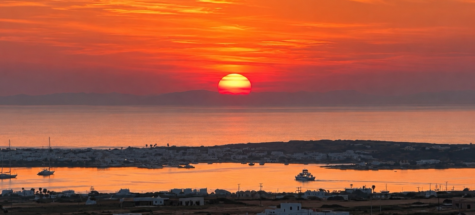 The sun setting over the bay and harbour, Paros