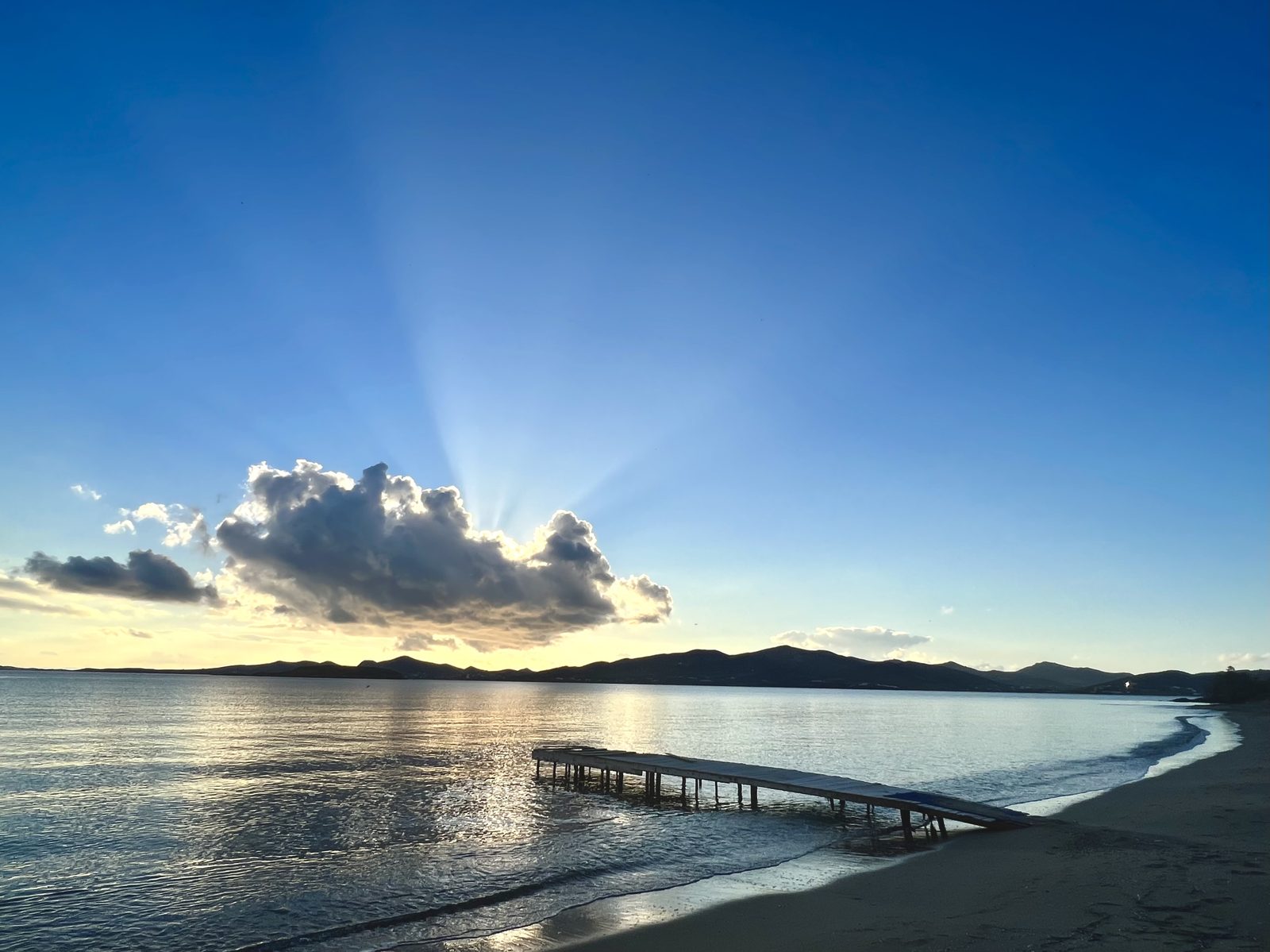 Early morning light over the beach jetty near Milos House
