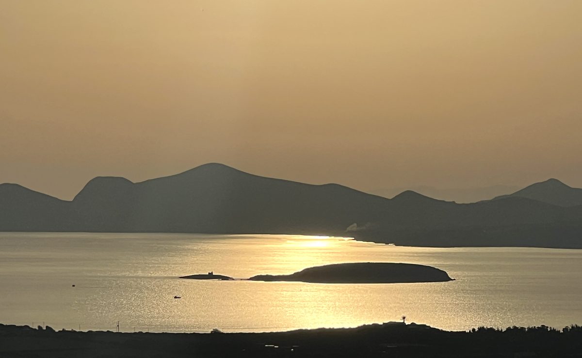 Golden evening light over the sea and islands from Paros