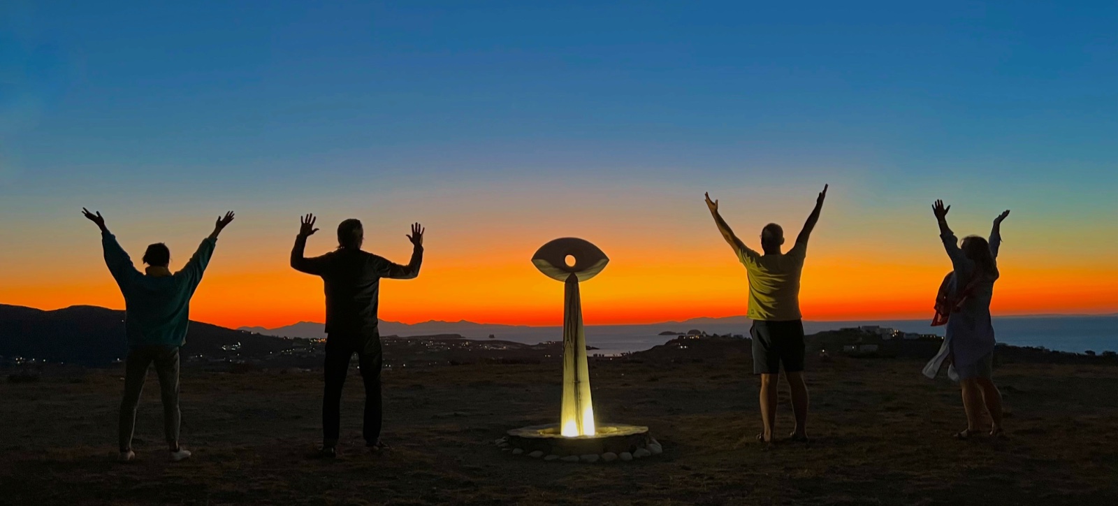 Friends greeting the sunset together at Milos House