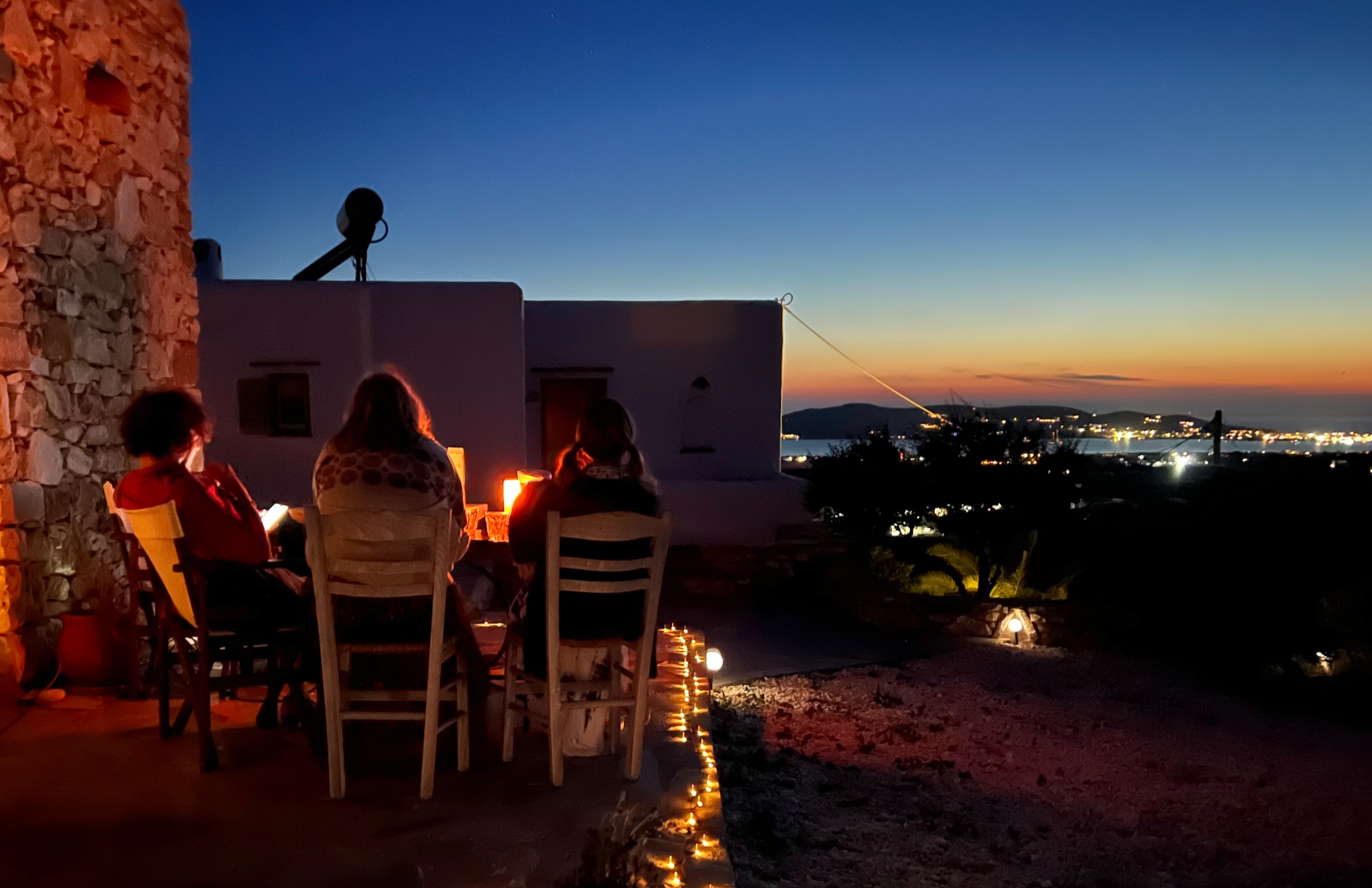 Guests sitting together watching the sunset from the terrace
