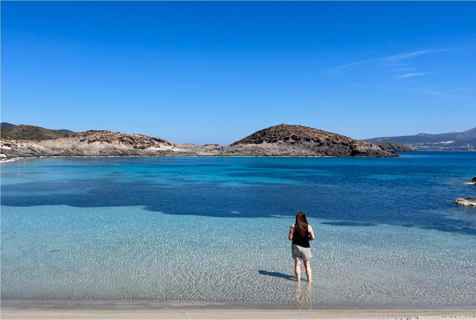 Wading into the clear waters of a Paros bay